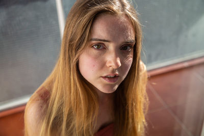 Close-up portrait of young woman with blond hair