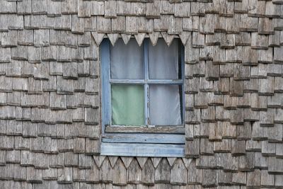 Close-up of window on wall of old building