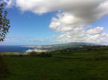 Scenic view of landscape against cloudy sky