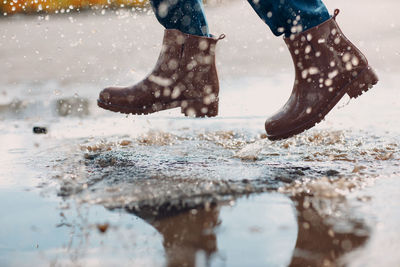 Low section of man jumping in water