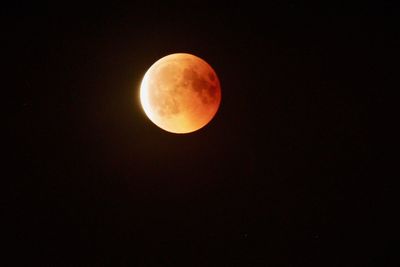 Low angle view of moon against sky at night