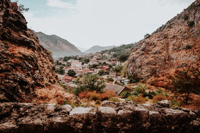 Town by mountains against sky