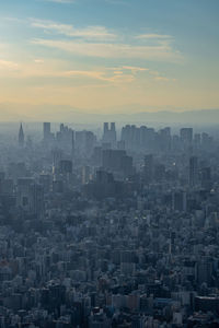 Aerial view of buildings in shinjuku city against sky during sunset