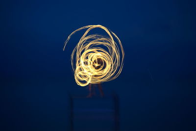 Low angle view of illuminated light against blue sky