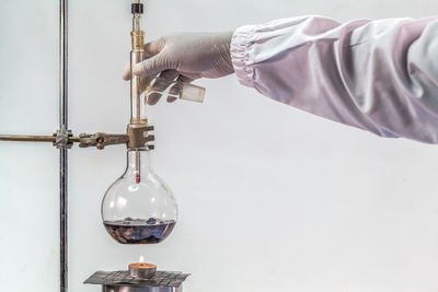 Cropped hand of scientist analyzing chemical in laboratory