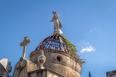 Low angle view of statue against sky