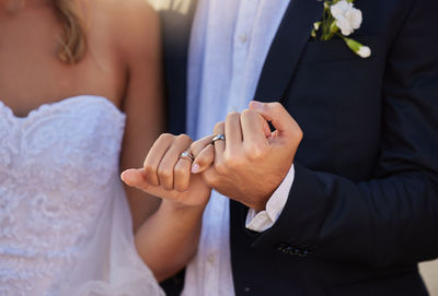 Midsection of bride with bridegroom