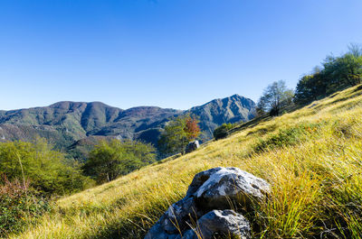 Scenic view of mountains against clear blue sky