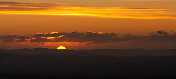 Scenic view of silhouette landscape against romantic sky at sunset