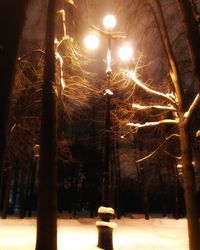 Low angle view of illuminated street light at night