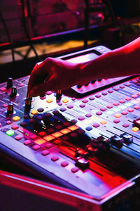 Cropped hand of person playing piano