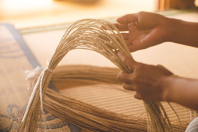 The process of weaving basket bags from fibers of plants native to miyako island, in okinawa japan.