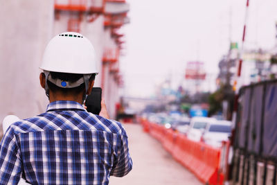 Rear view of man standing in city