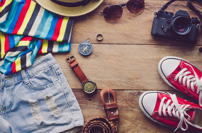 High angle view of travel and fashion accessory on table