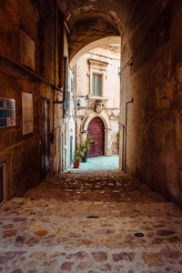 Covered alleyway in the sassi of matera, vertical