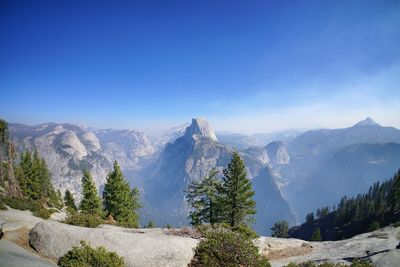 Scenic view of mountains against clear blue sky