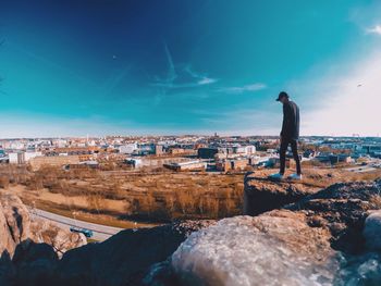 Man standing by sea against blue sky