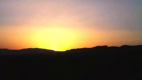 Scenic view of silhouette mountains against sky during sunset