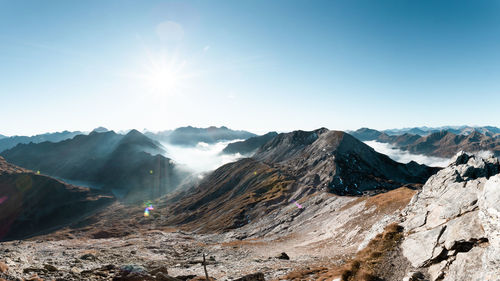 Scenic view of mountains against clear sky on sunny day