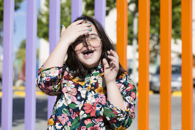 Teenager girl with down syndrome wearing glasses and smiling