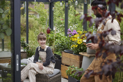 Friends talking in greenhouse