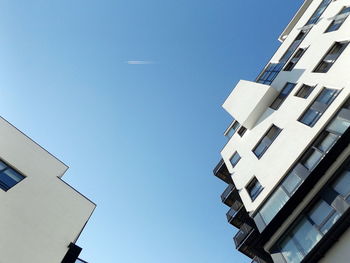 Low angle view of modern building against clear blue sky