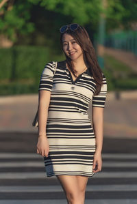 Young woman standing on road