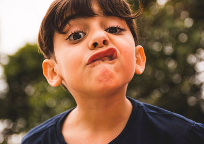 Close-up portrait of boy making a face