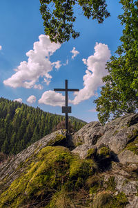 Low angle view of cross against sky