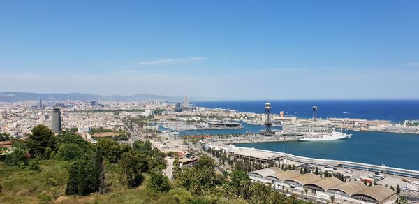 High angle view of buildings by sea against sky