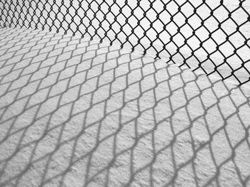 Chainlink fence on snow covered field