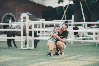 Cheerful mother and son at ranch