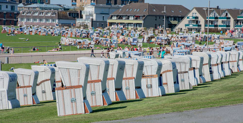 Hooded beach chairs against houses in city