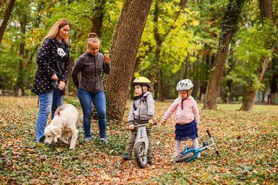 Rear view of people with dog on plants