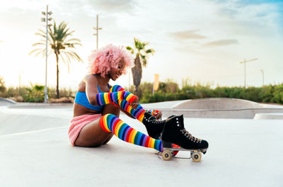 Full length of woman sitting on road