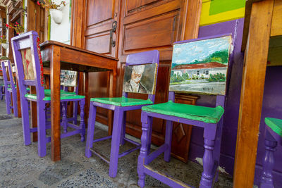 Empty chairs and tables in building