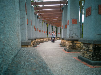 Rear view of people walking on building