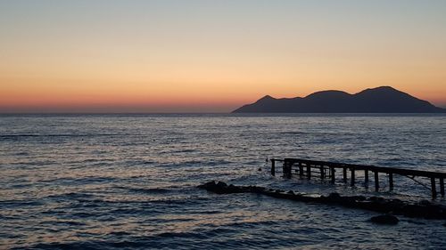 Scenic view of sea against clear sky during sunset