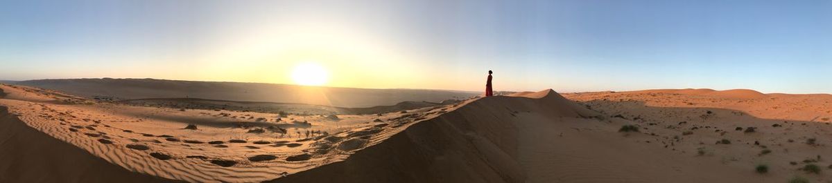 Panoramic view of desert against sky during sunset