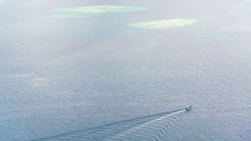 Distant view of boat moving on sea