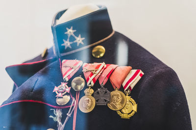 Close-up of medals on military uniform seen through glass window