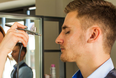 Side view of man smoking cigarette