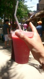 Cropped image of hand holding smart phone