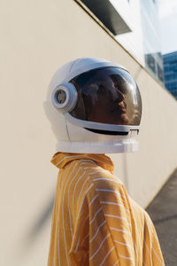 Woman wearing space helmet on sunny day