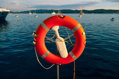 Red boat in lake against sky