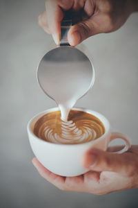 Hand holding coffee cup