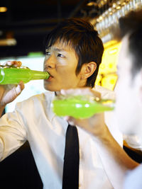 Close-up of friends drinking at bar