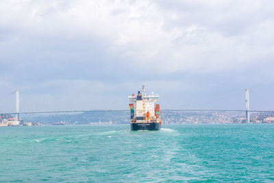 Ship sailing on sea against sky