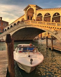 Arch bridge over canal against sky