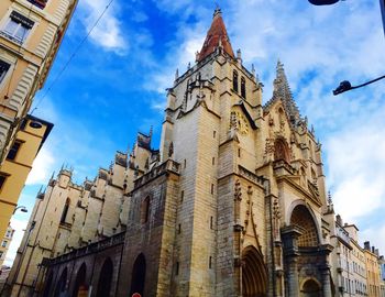 Low angle view of church against cloudy sky